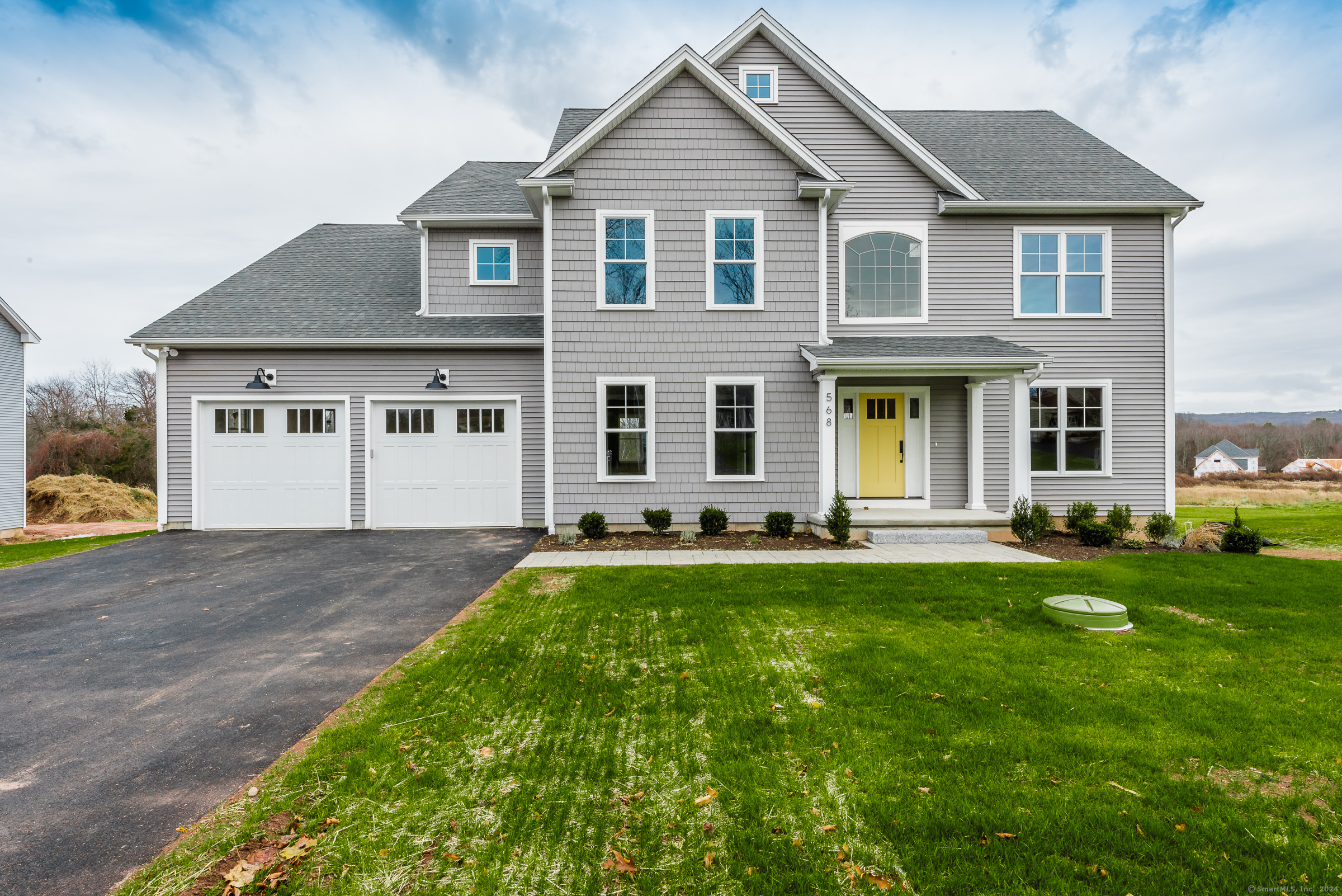 a front view of a house with a yard and garage