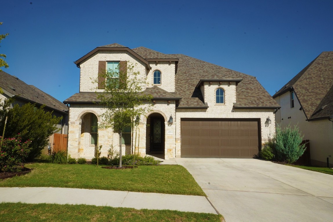 a front view of a house with a garden