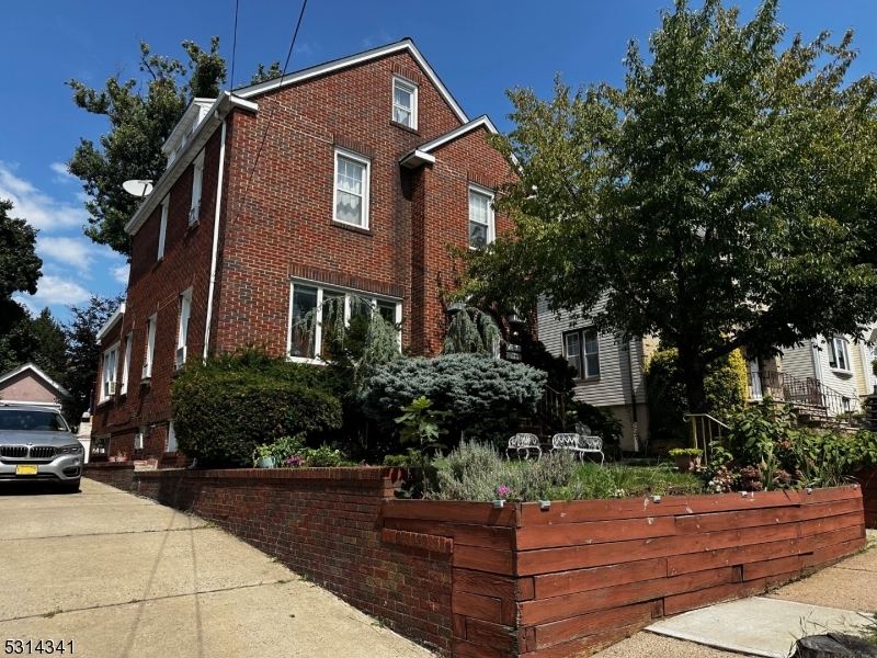 a front view of a house with lots of trees