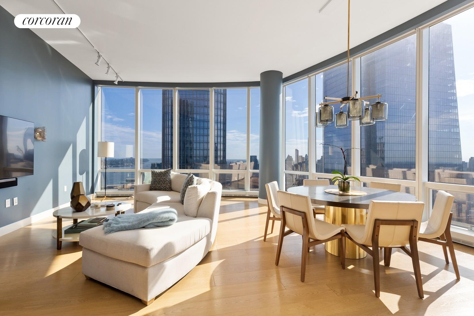 a living room with furniture and large windows