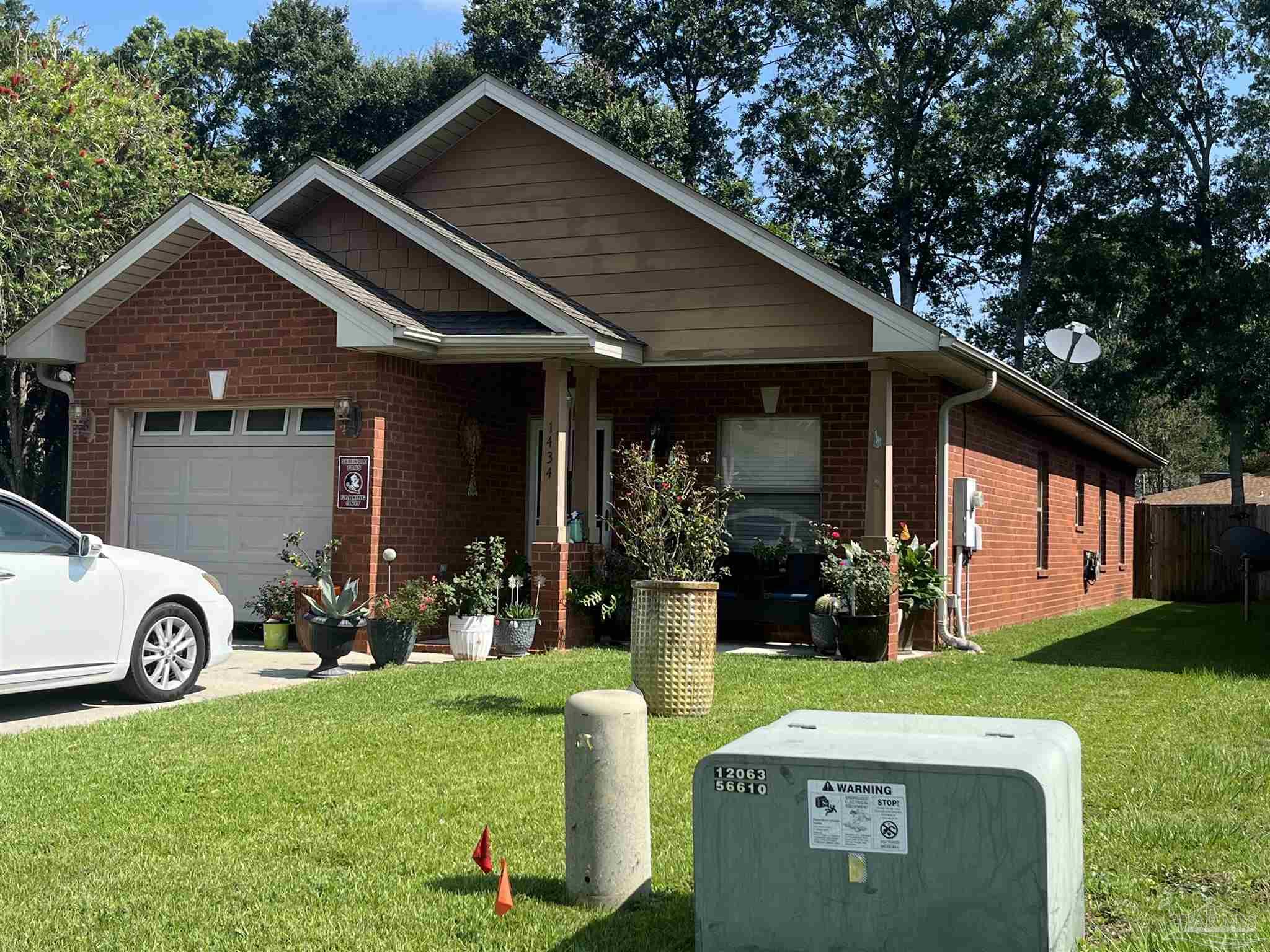 a front view of house with a garden