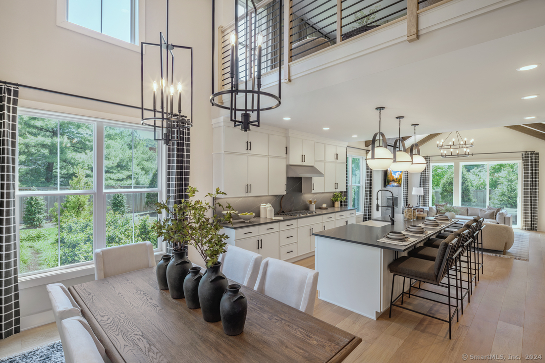 dining room with 2 story windows, open to the great room and large kitchen