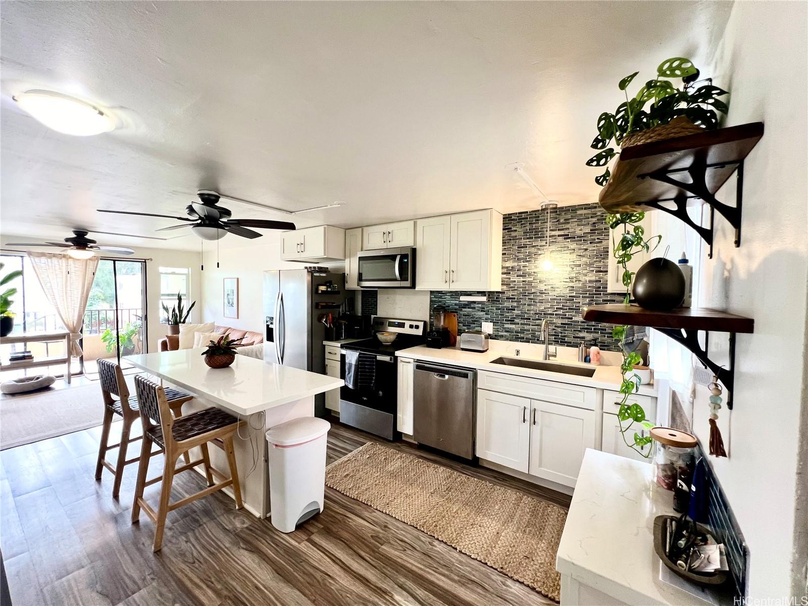 Light and breezy updated kitchen with stone countertops and updated appliances