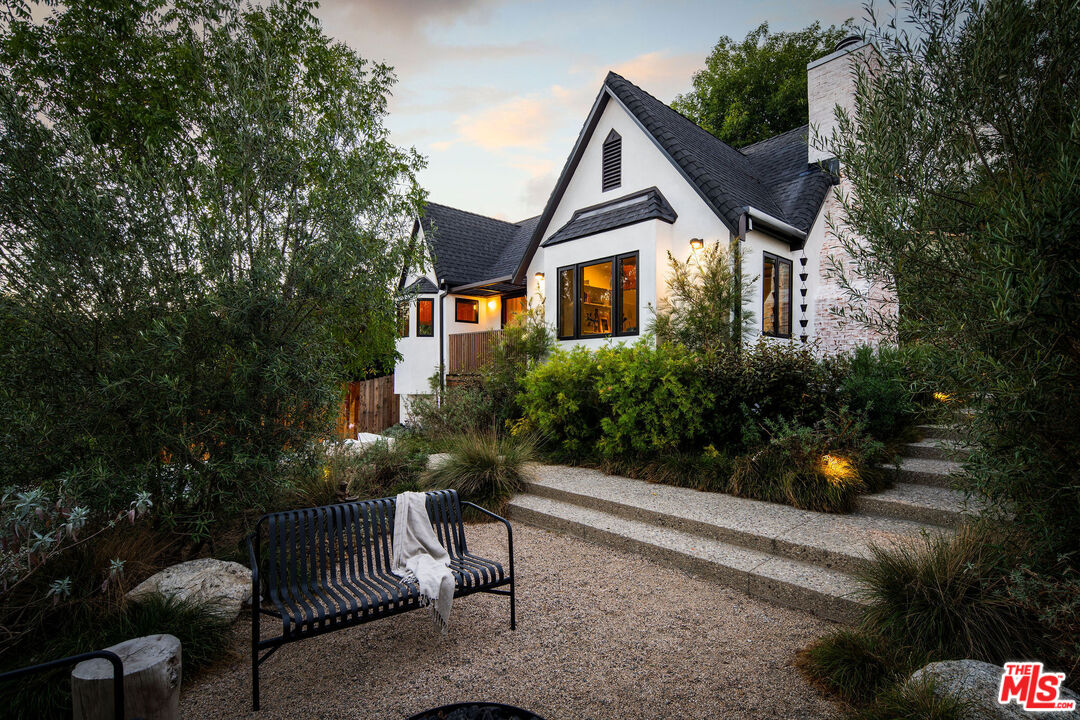 a front view of a house with a yard and sitting area