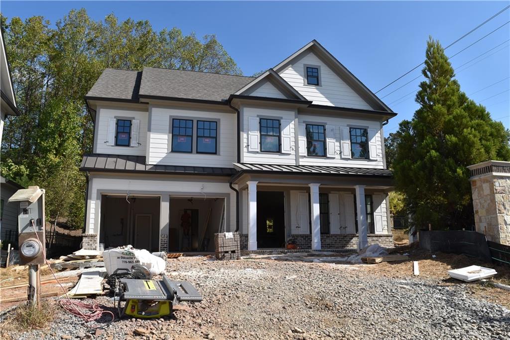 a front view of a house with a yard and seating space