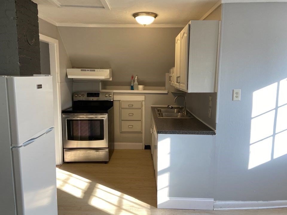 a kitchen with stainless steel appliances a stove a microwave and a refrigerator