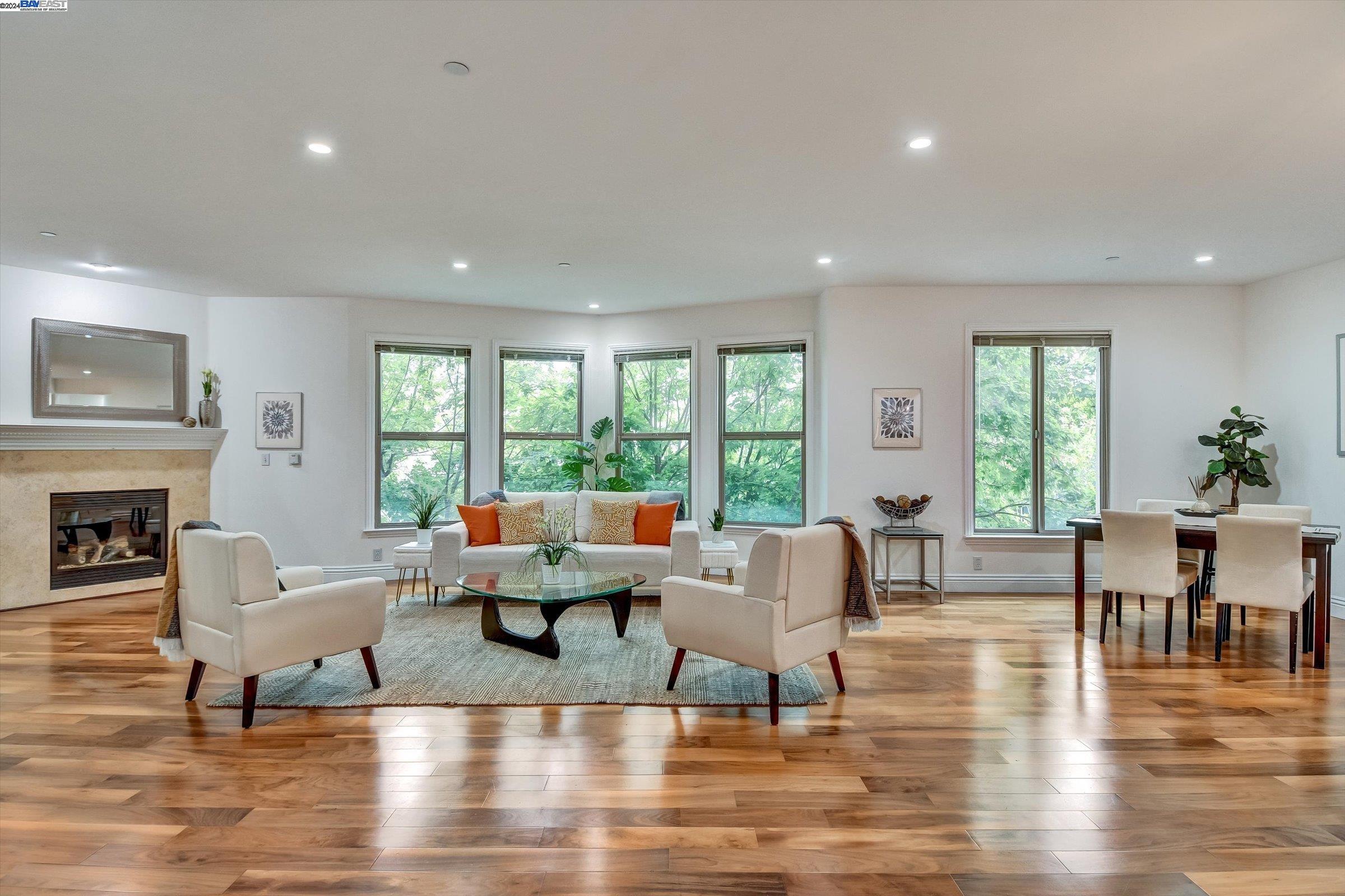 a living room with fireplace furniture and a large window