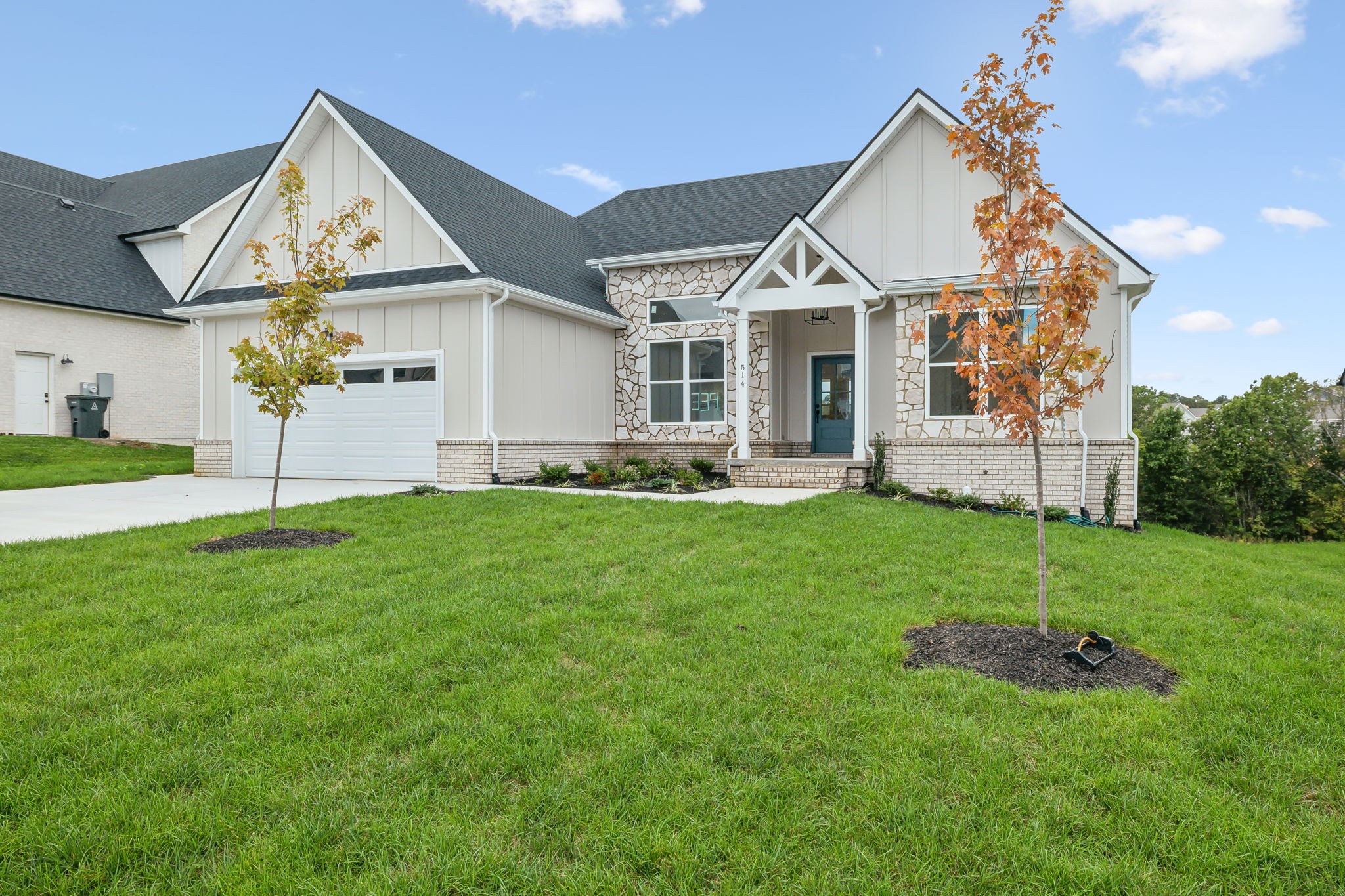 a view of a house with a yard and porch