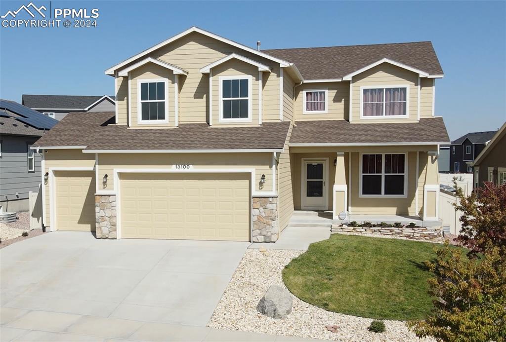 a front view of a house with a yard and garage