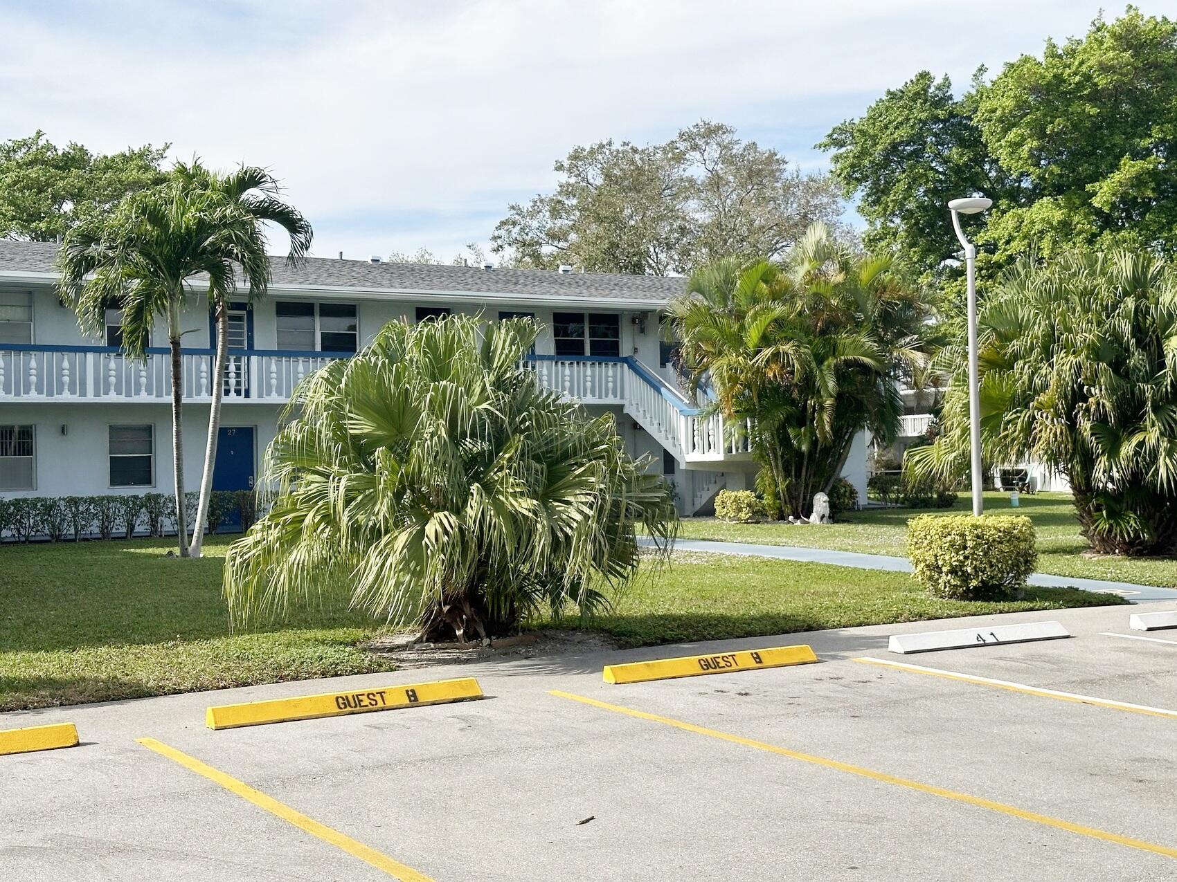 a view of a swimming pool with a yard and plants