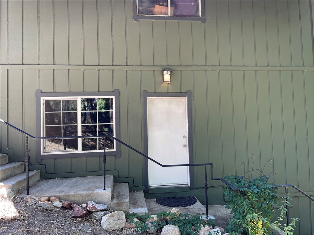 a view of a door and chair in the patio