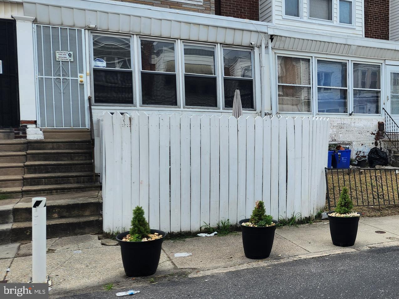 a view of a house with potted plants