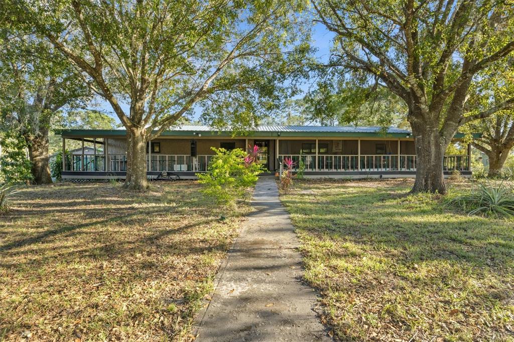 a front view of house with yard and green space