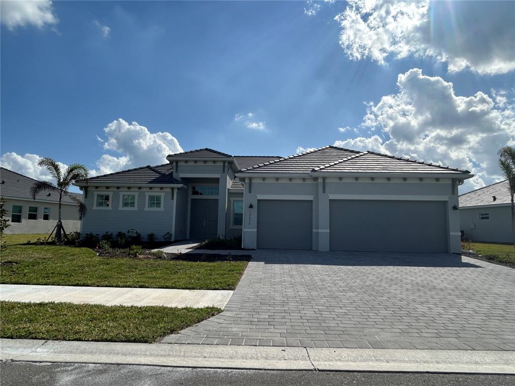 a front view of a house with a yard and a garage