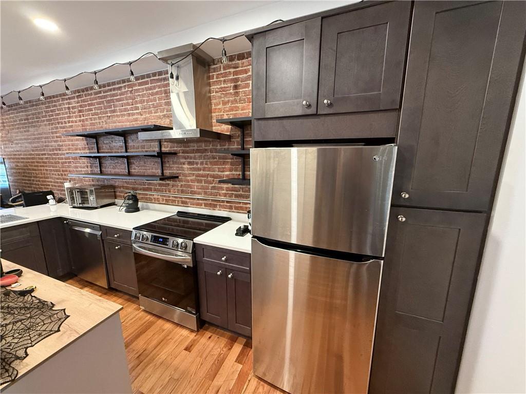 a kitchen with a sink stove and refrigerator