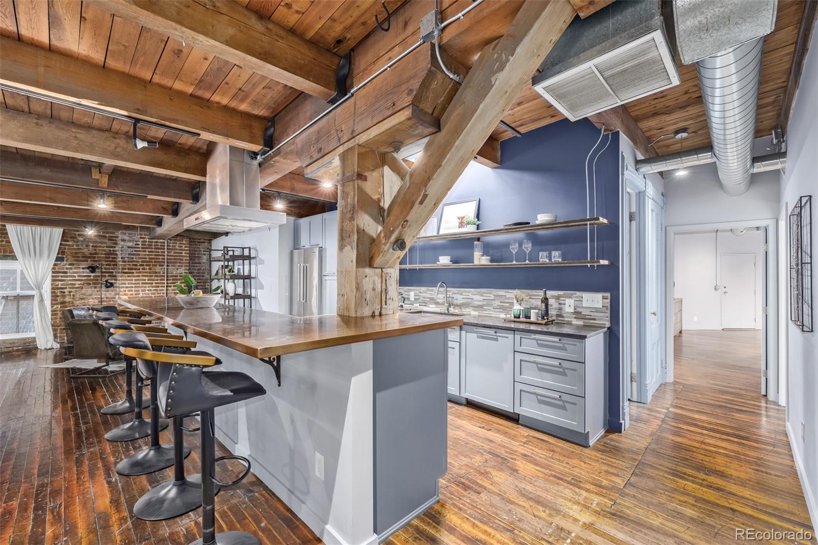 a open kitchen with stainless steel appliances granite countertop a stove and cabinets with wooden floor