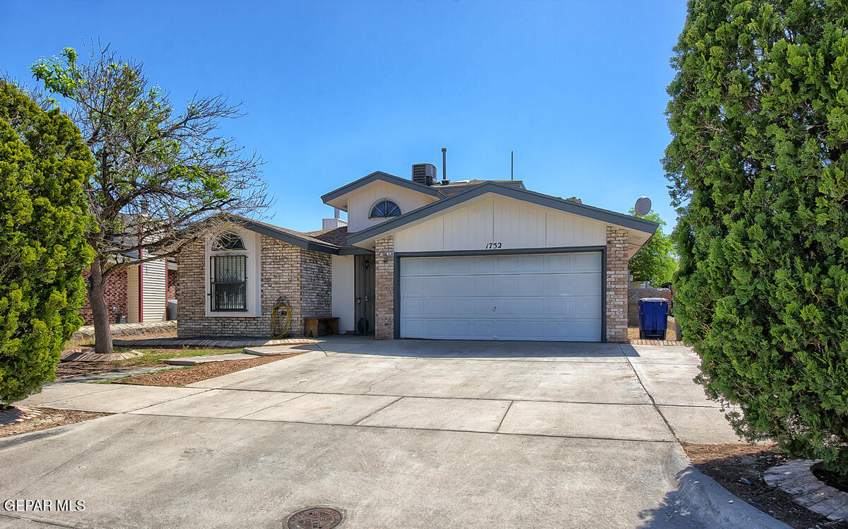 a view of a house with a yard and garage