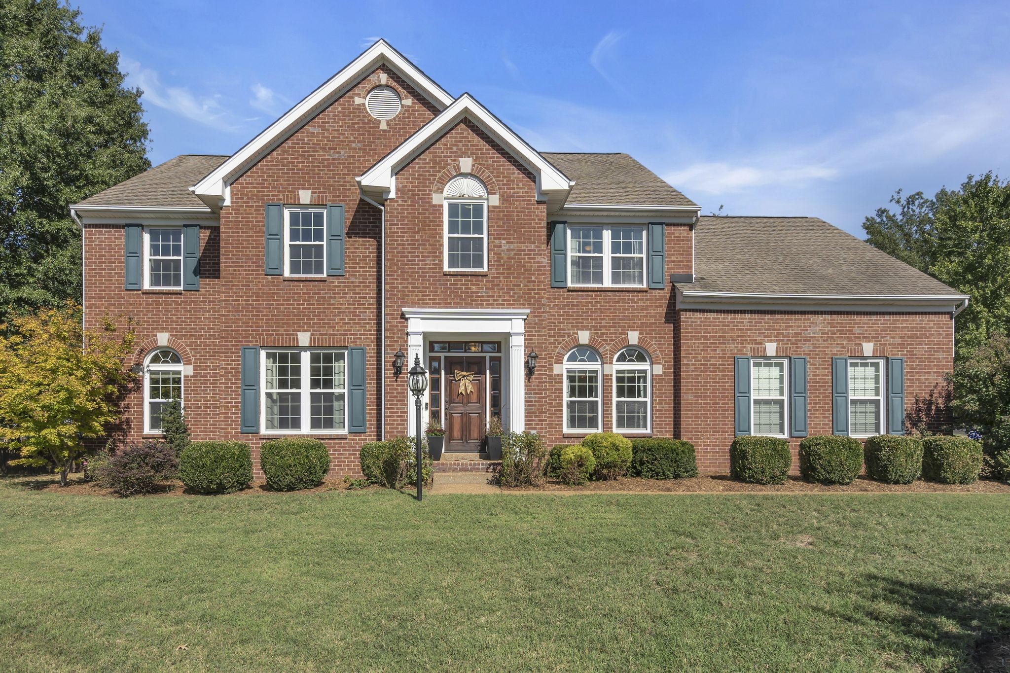 a front view of a house with a yard