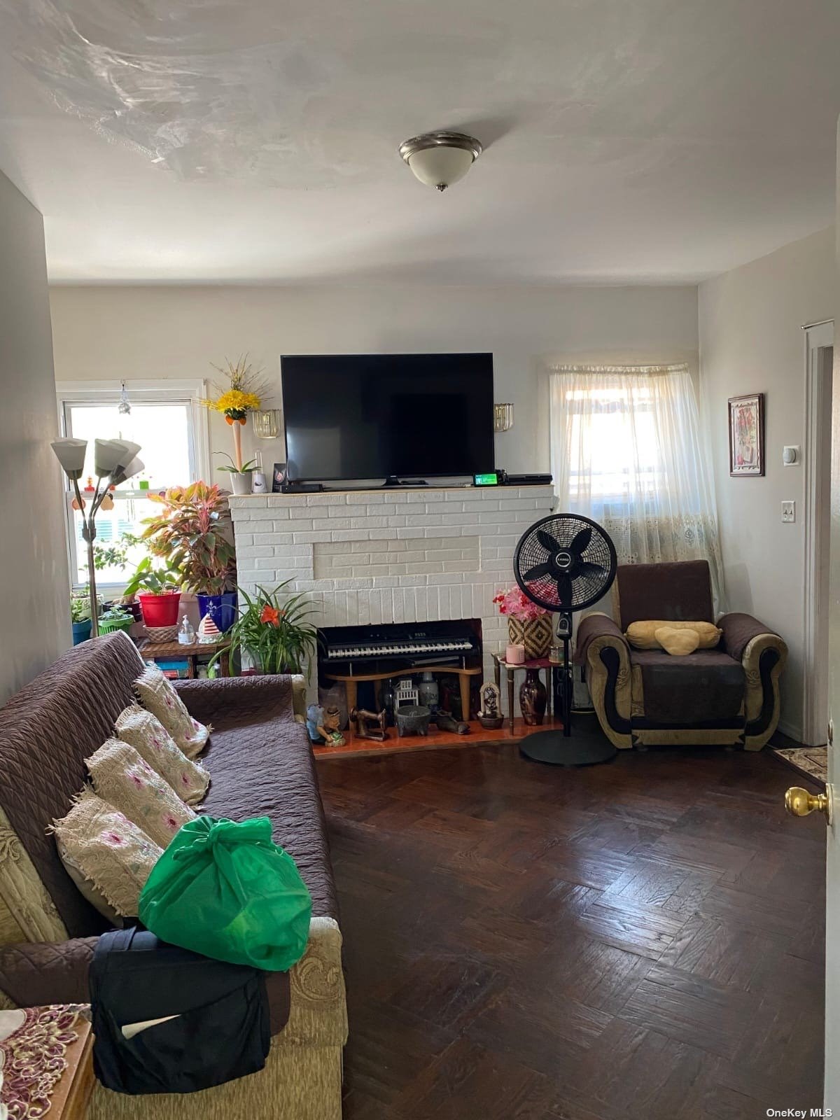 a living room with furniture a flat screen tv and a fireplace