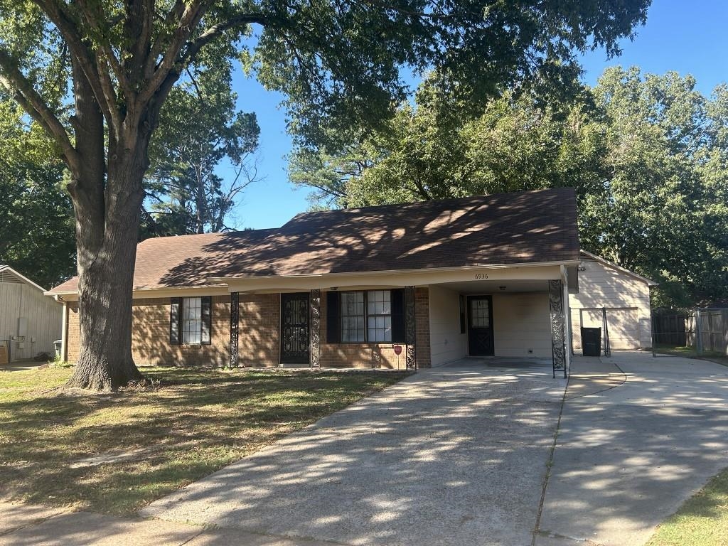 Ranch-style home with a front lawn