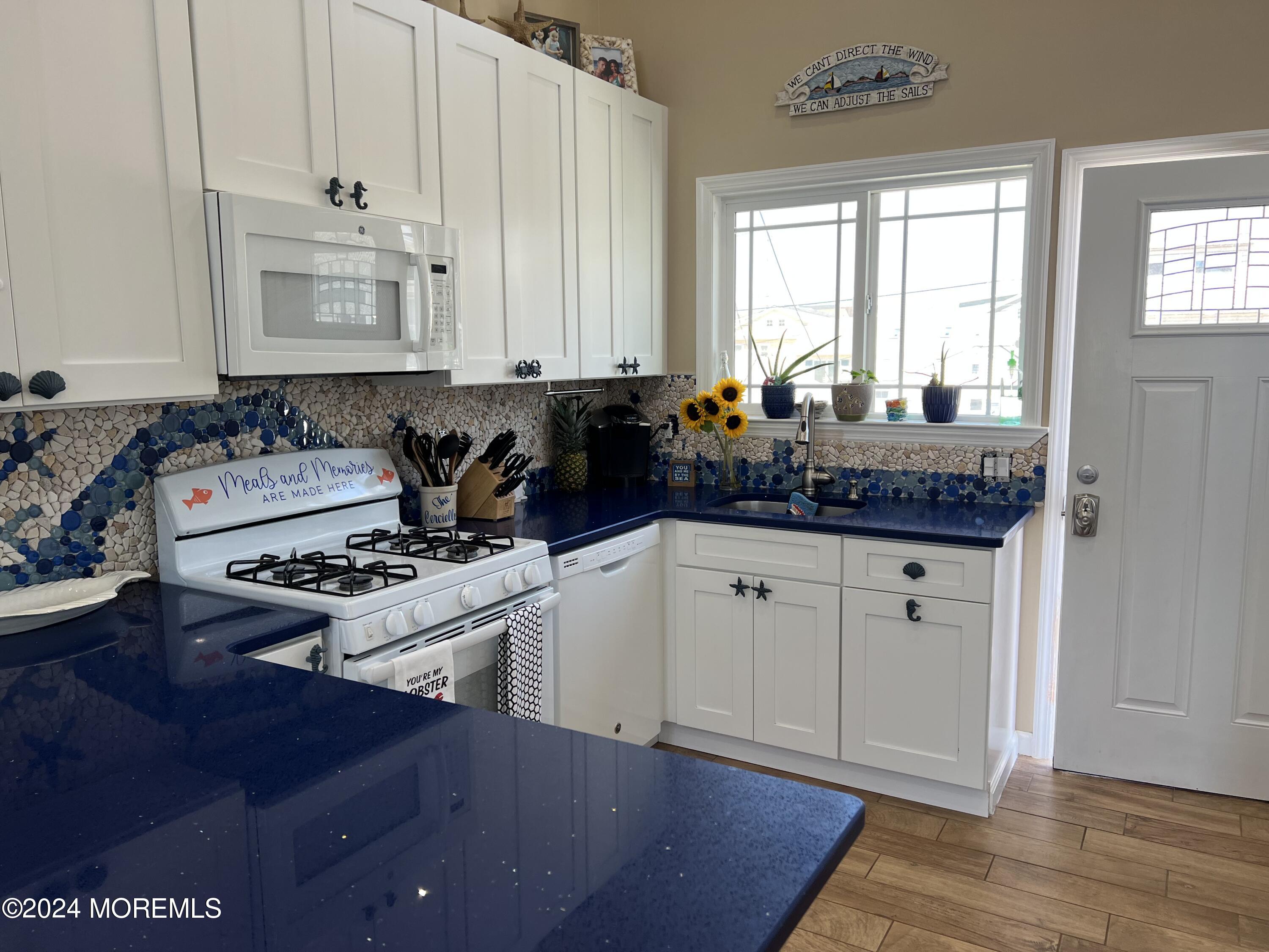 a kitchen with stainless steel appliances a stove a sink and cabinets