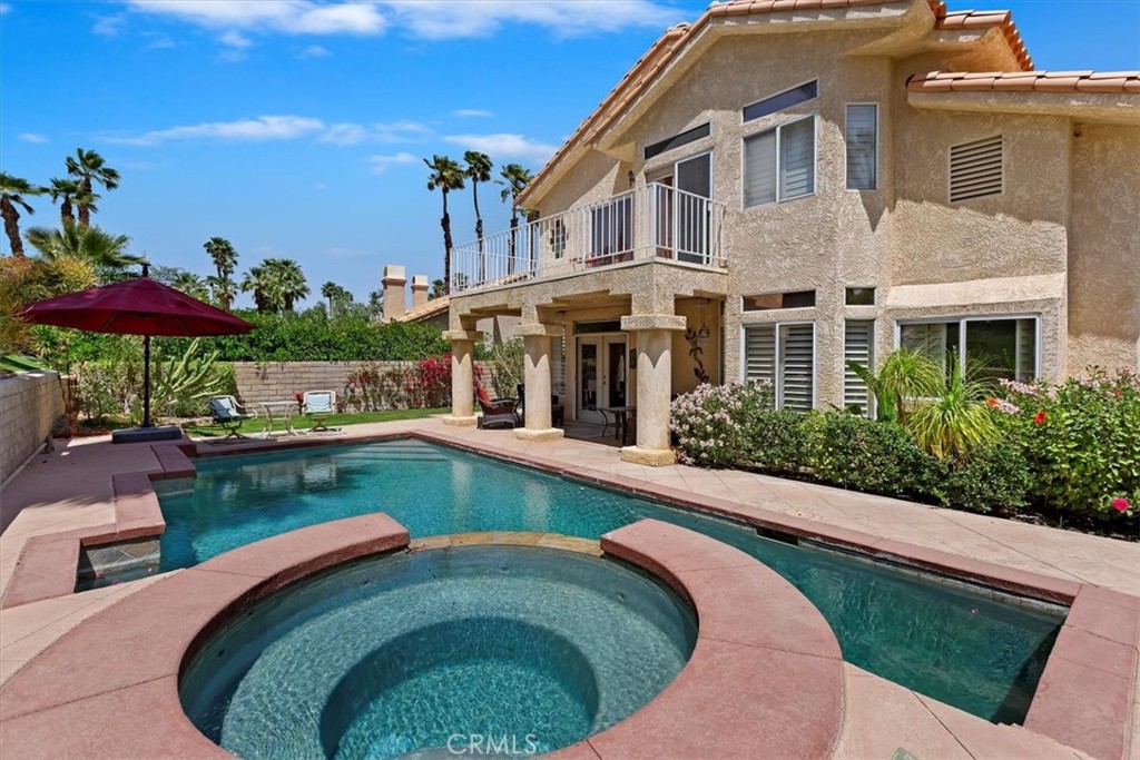 a swimming pool with outdoor seating