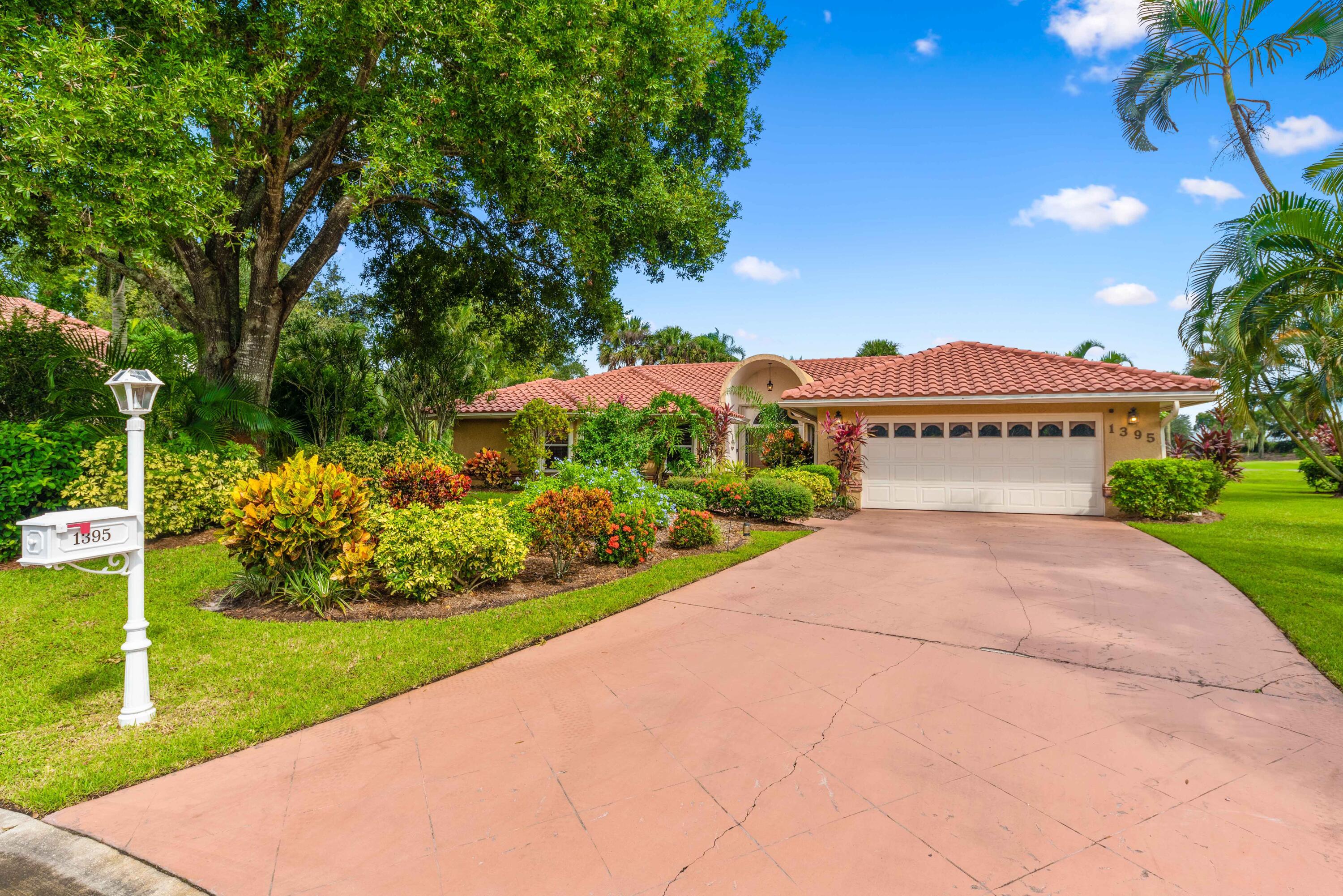 a view of house with a garden and pathway