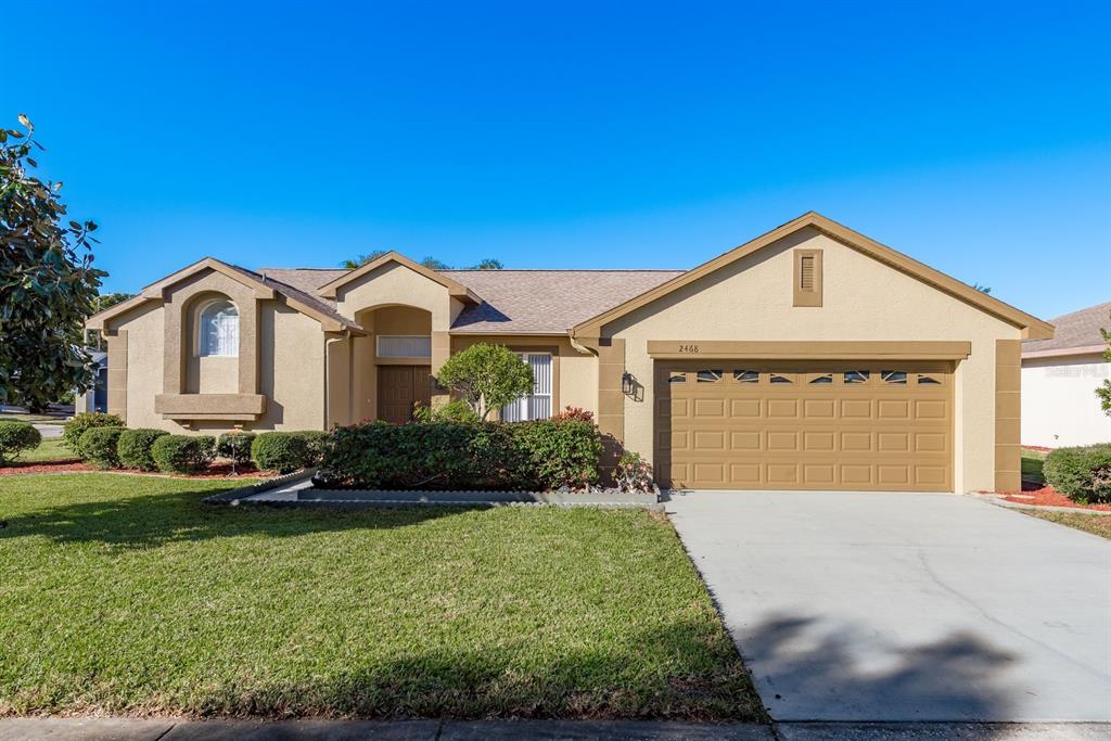 a front view of a house with a yard and garage