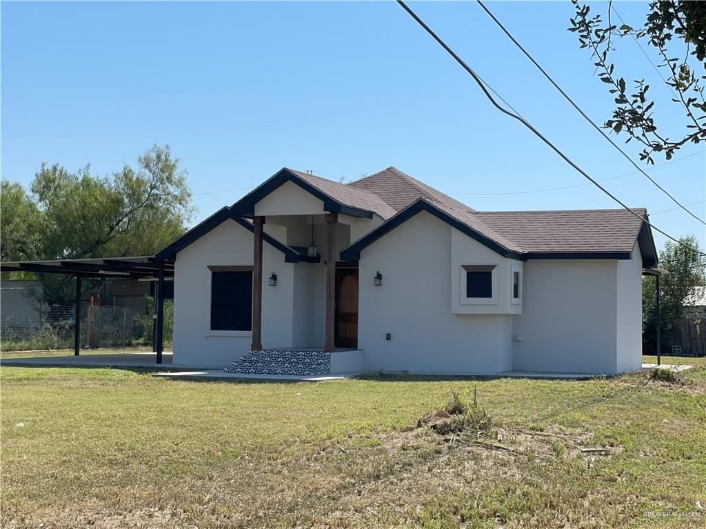 View of front of property with a front yard