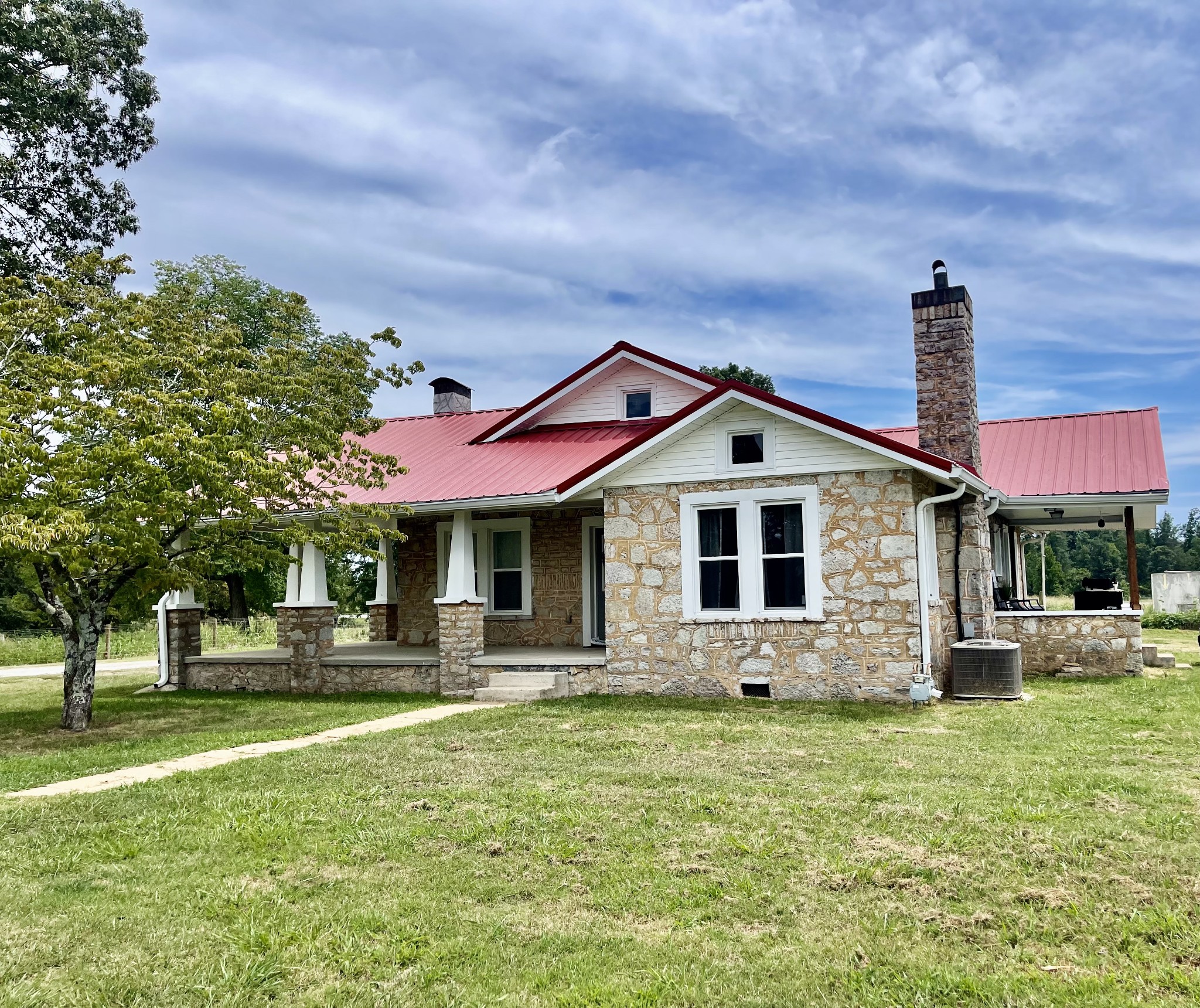 a front view of a house with a yard table and chairs