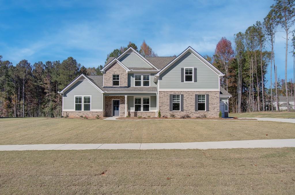 a front view of a house with a yard and garage