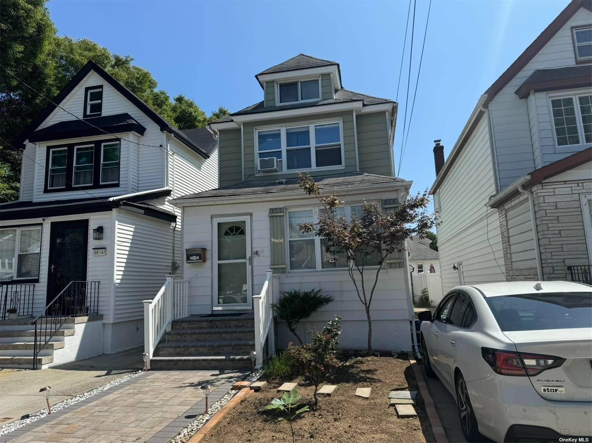 a front view of a house with parking space