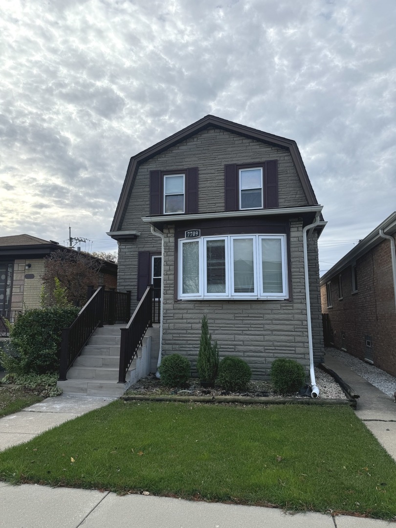 a front view of a house with a yard