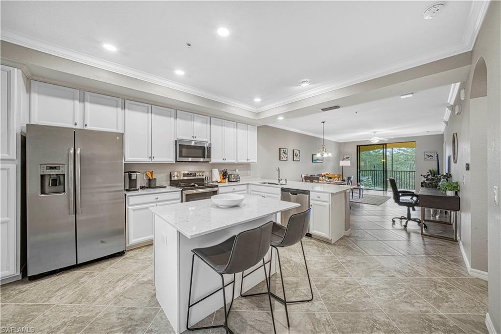 a kitchen with a refrigerator a counter top space and appliances