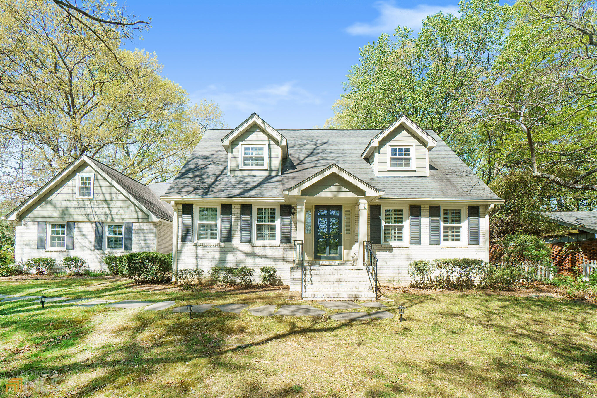 a front view of a house with a garden