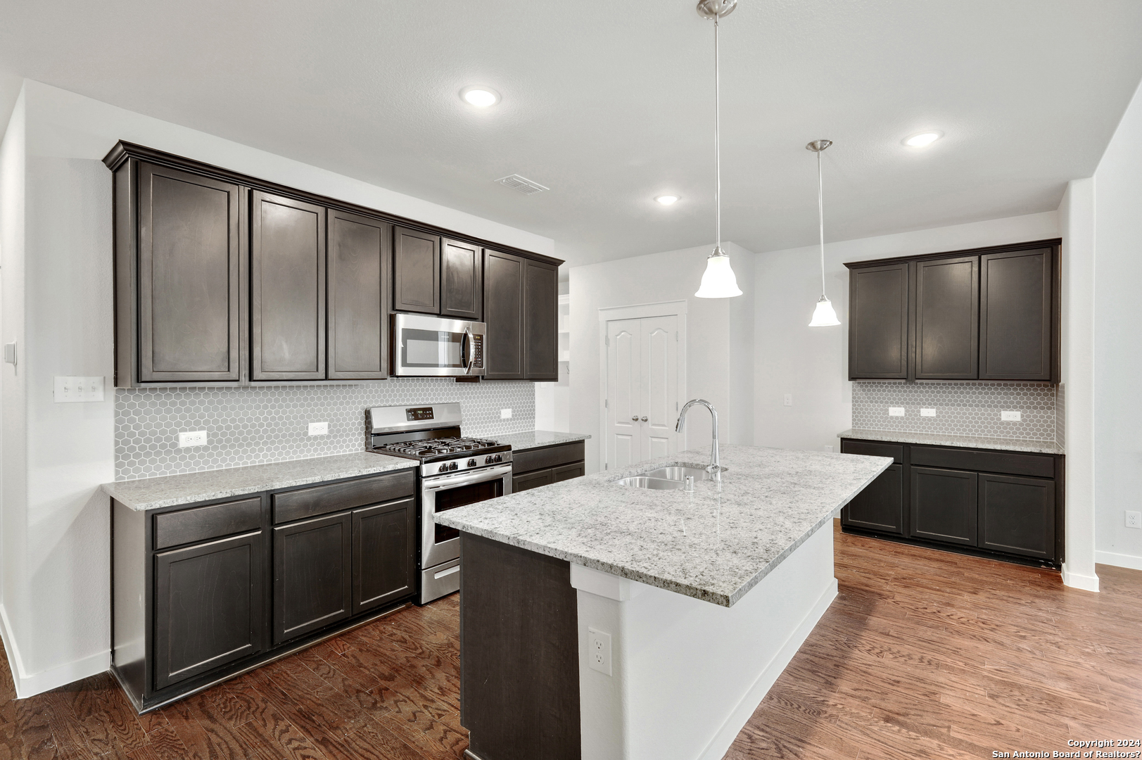 a kitchen with granite countertop stainless steel appliances and sink