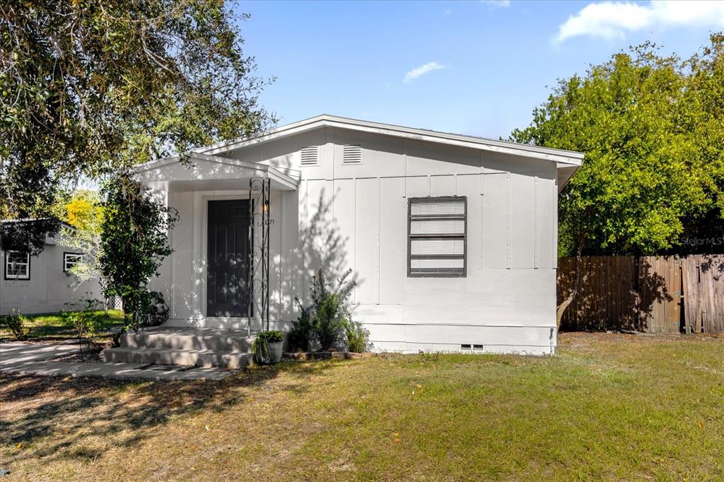 a view of house with backyard space and garden