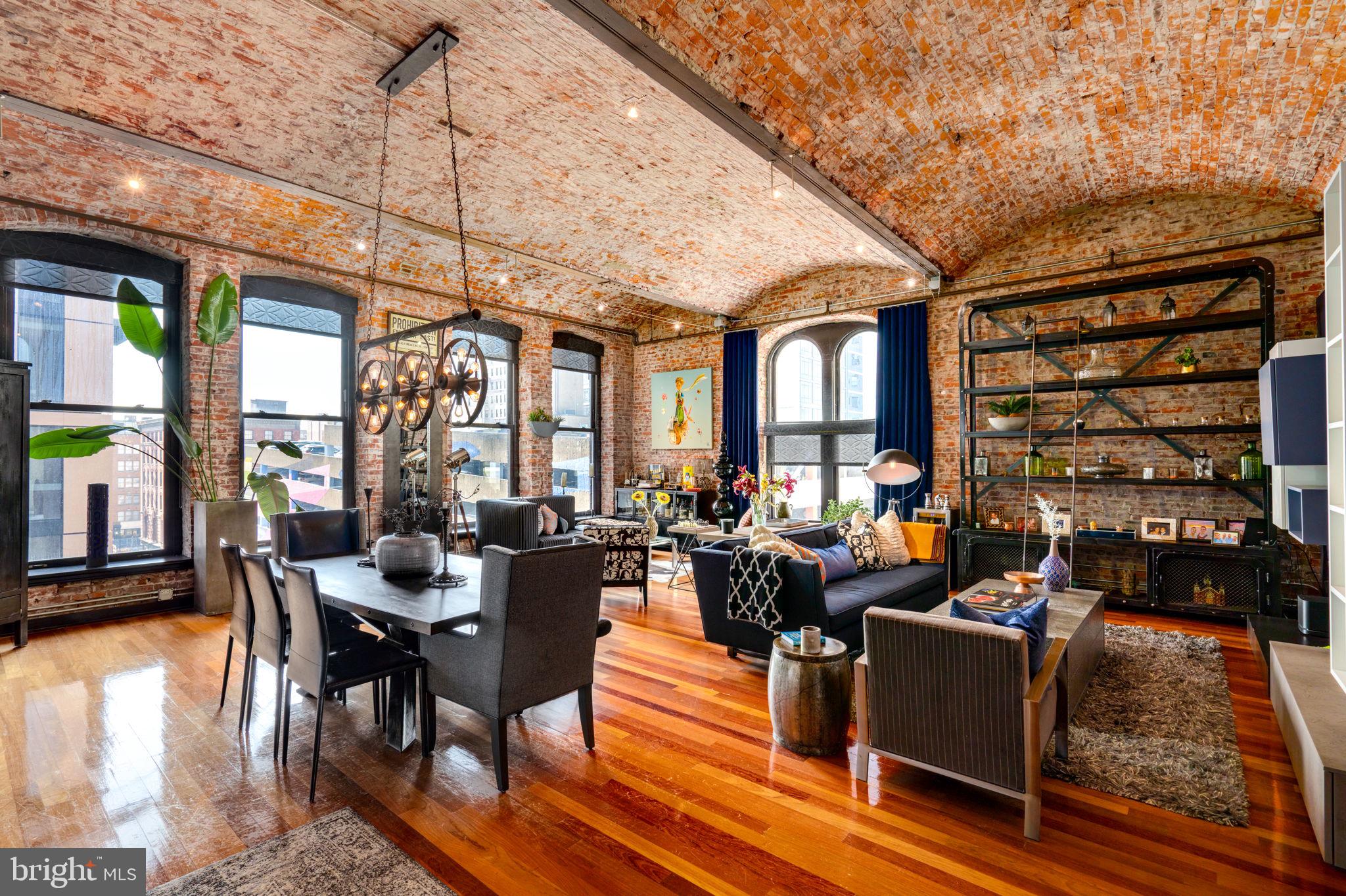 a living room with furniture a rug and a chandelier