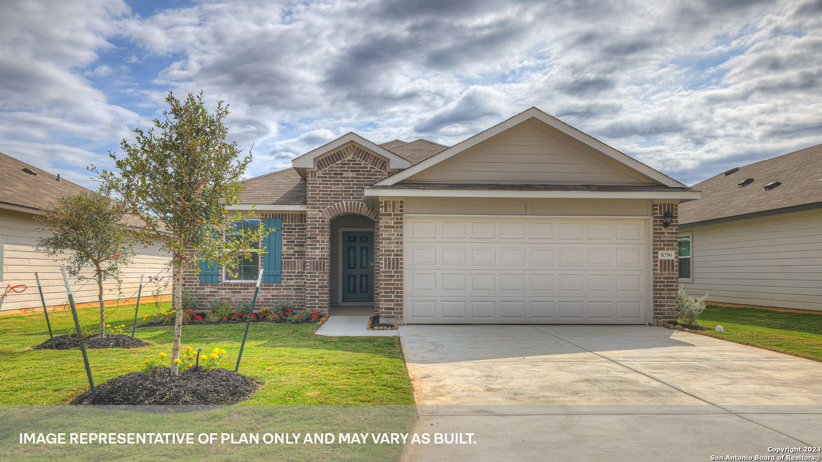 a front view of a house with a yard and garage