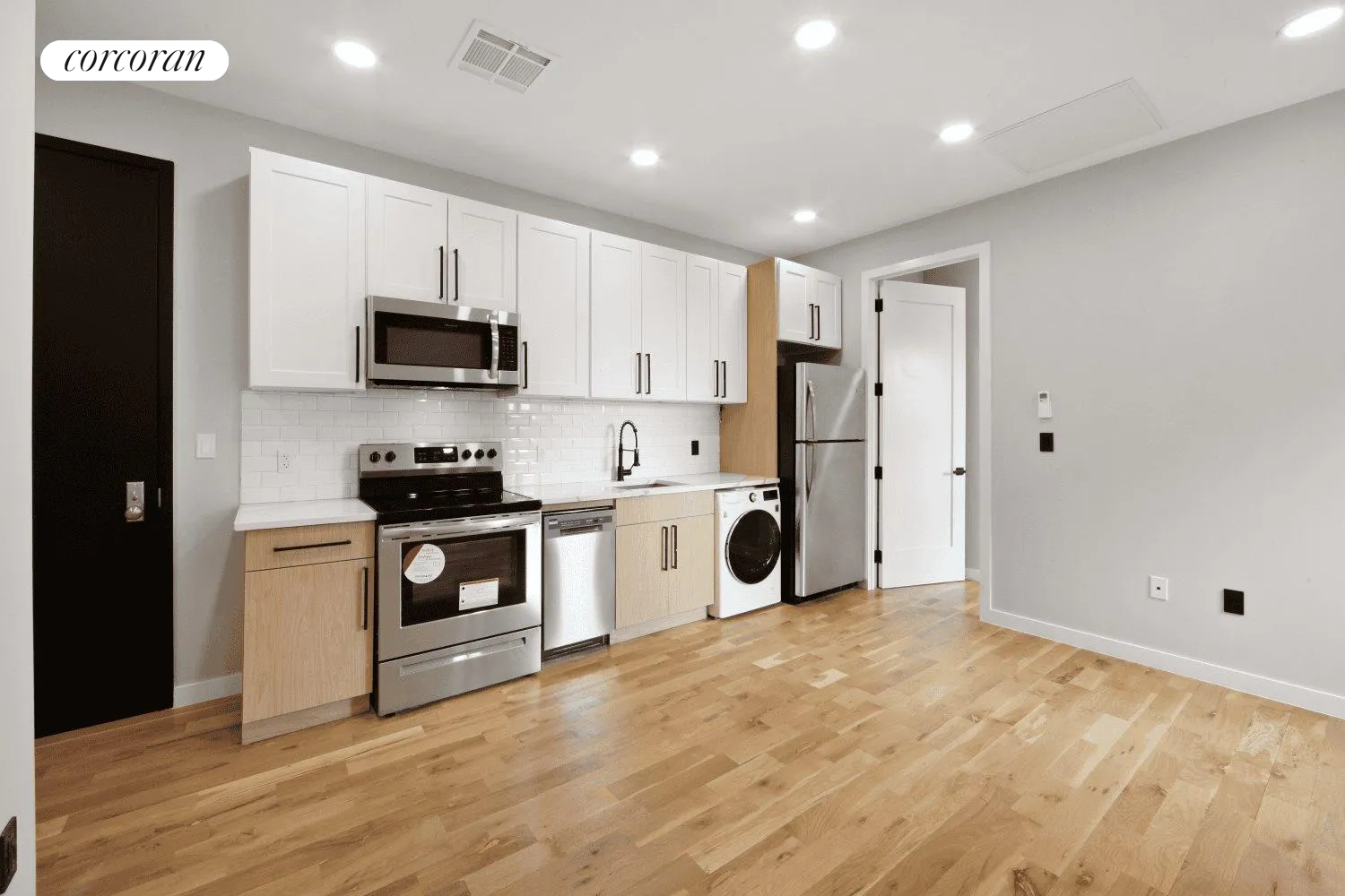 a kitchen with white cabinets and white appliances