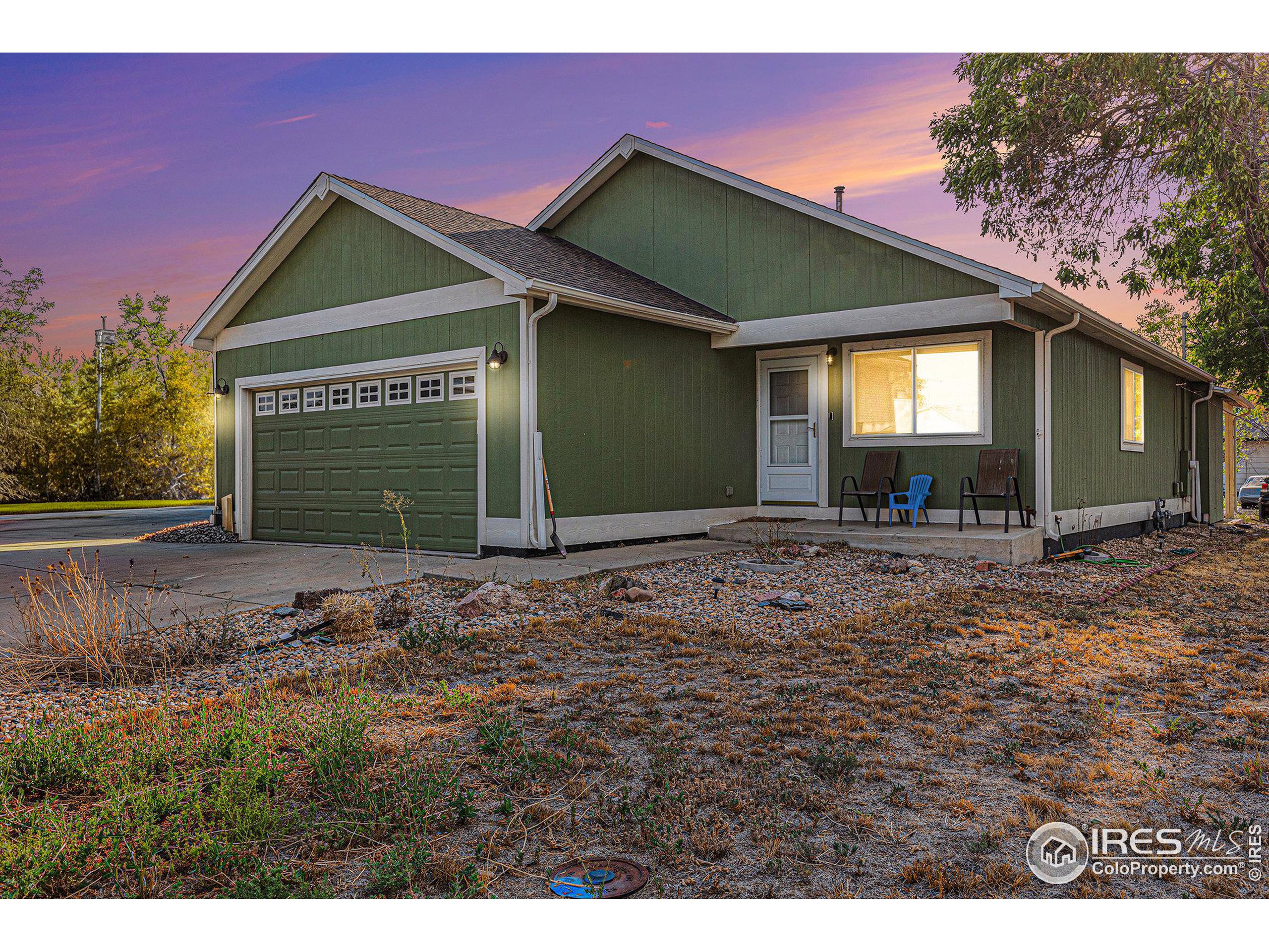 a view of a house with a yard and garage