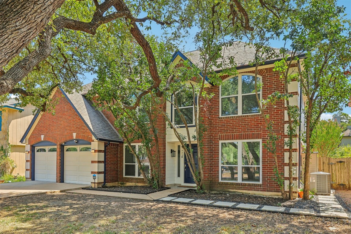 front view of a house with a tree