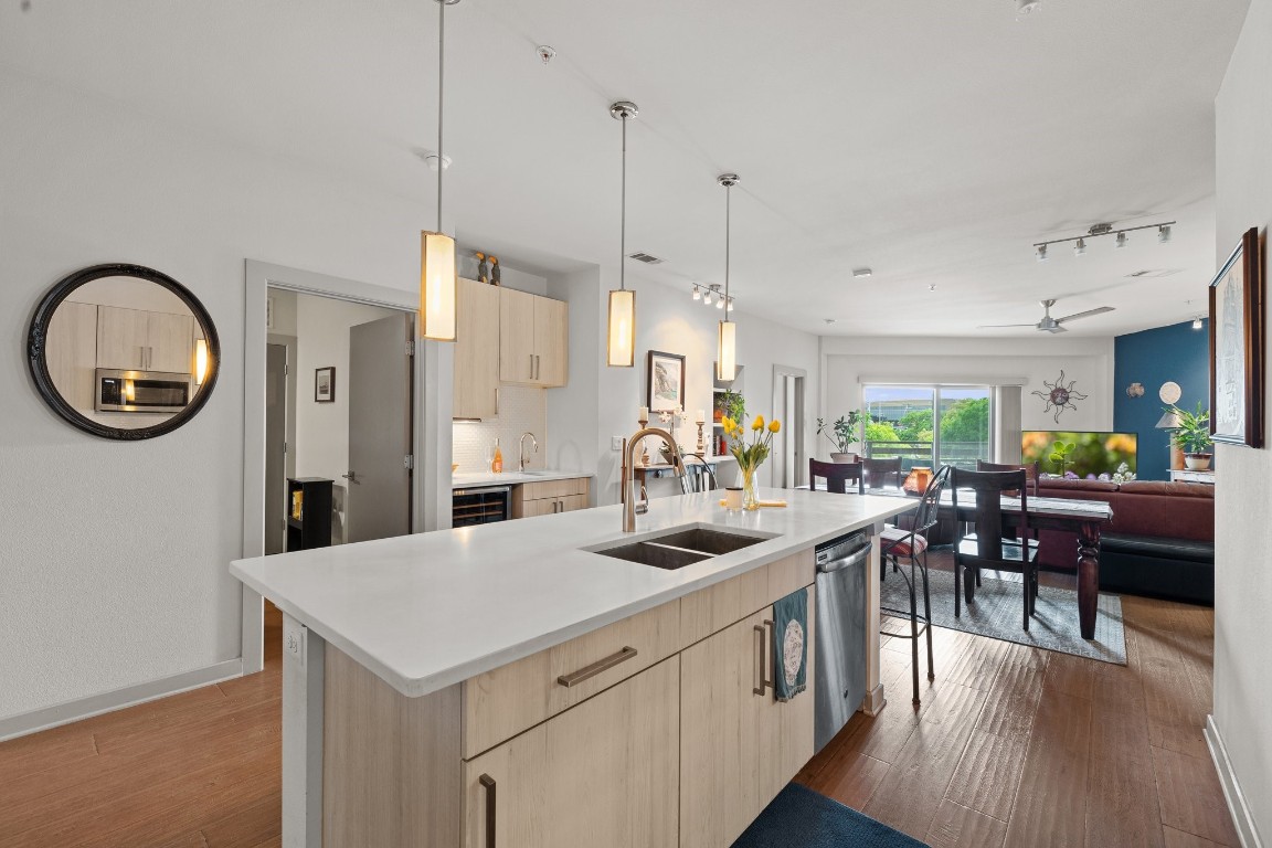 a kitchen with a table chairs and a chandelier