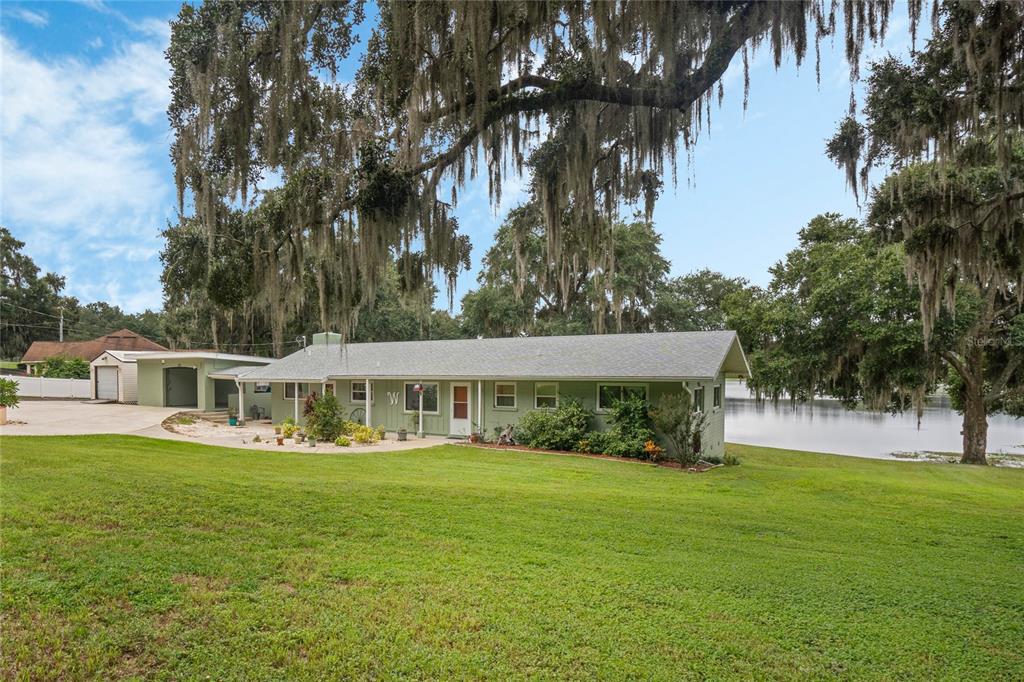 a view of house with yard and entertaining space