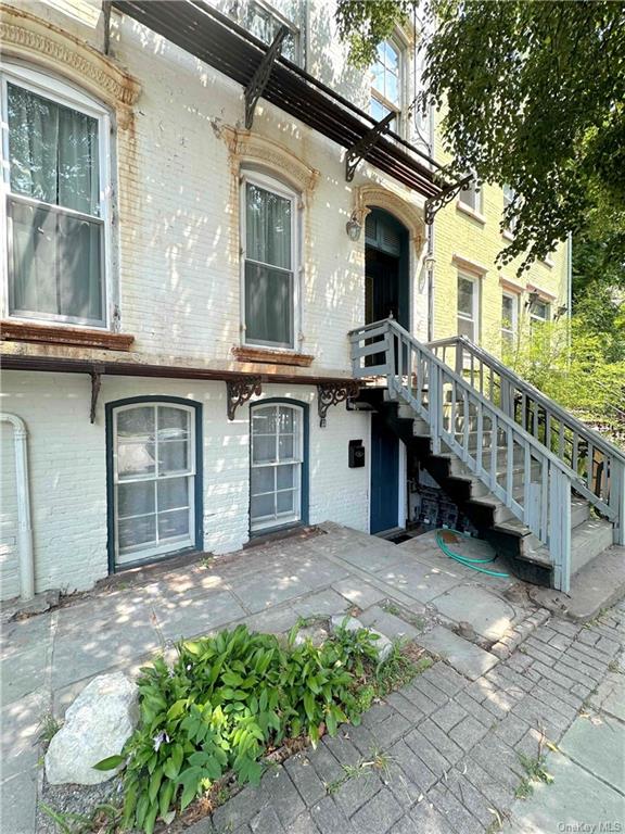 a view of a house with a large window and a yard