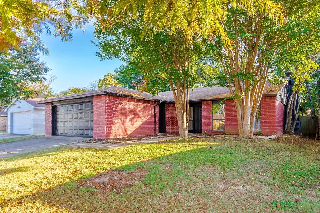 a view of a house with backyard and tree