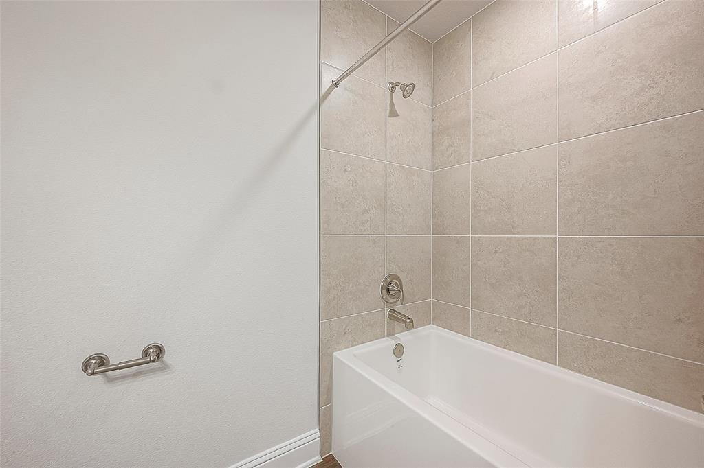 a white bath tub sitting next to a white sink and vanity