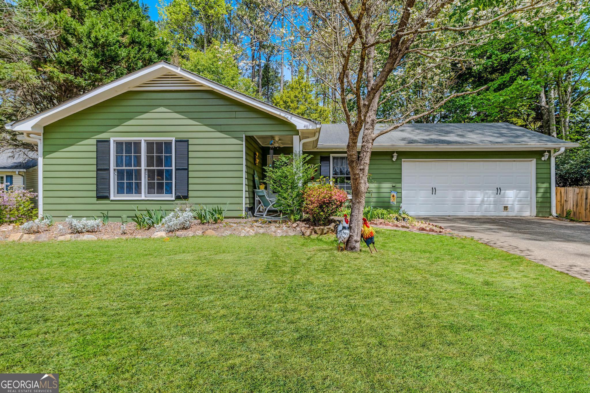 a front view of house with yard and green space