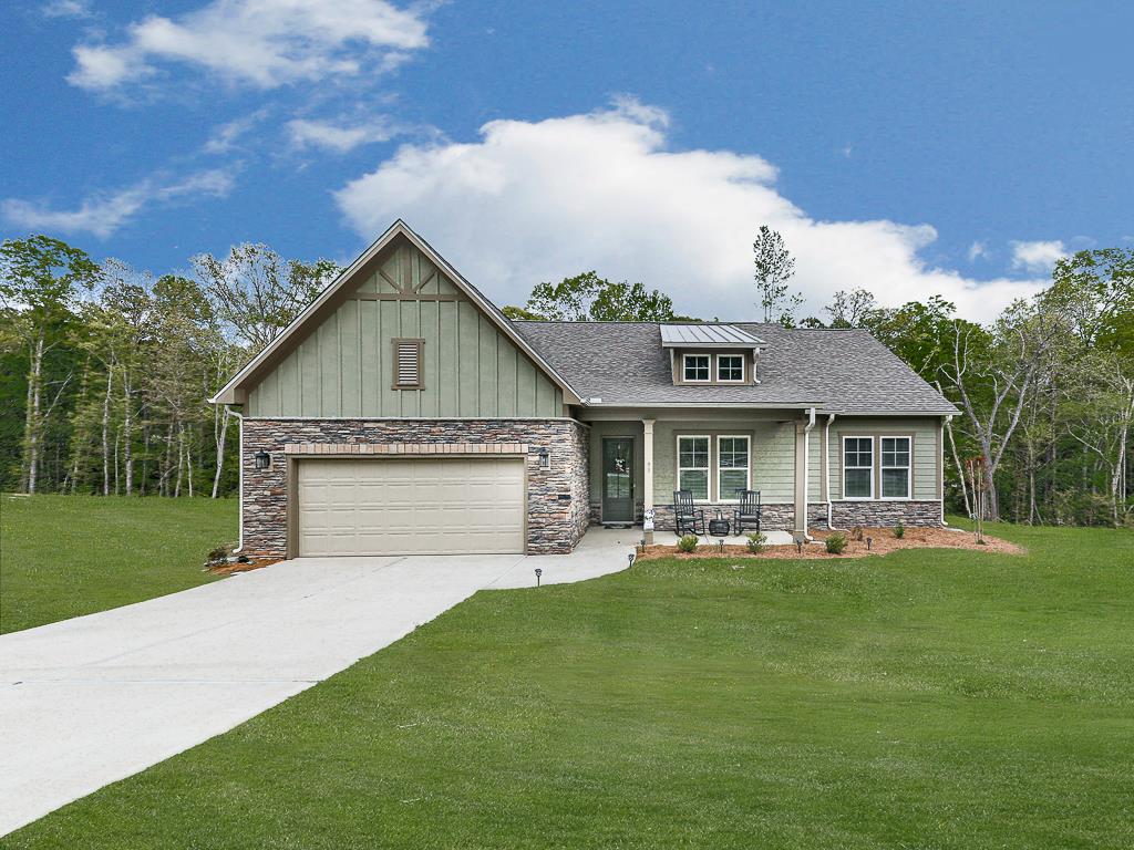 a front view of house with yard and green space