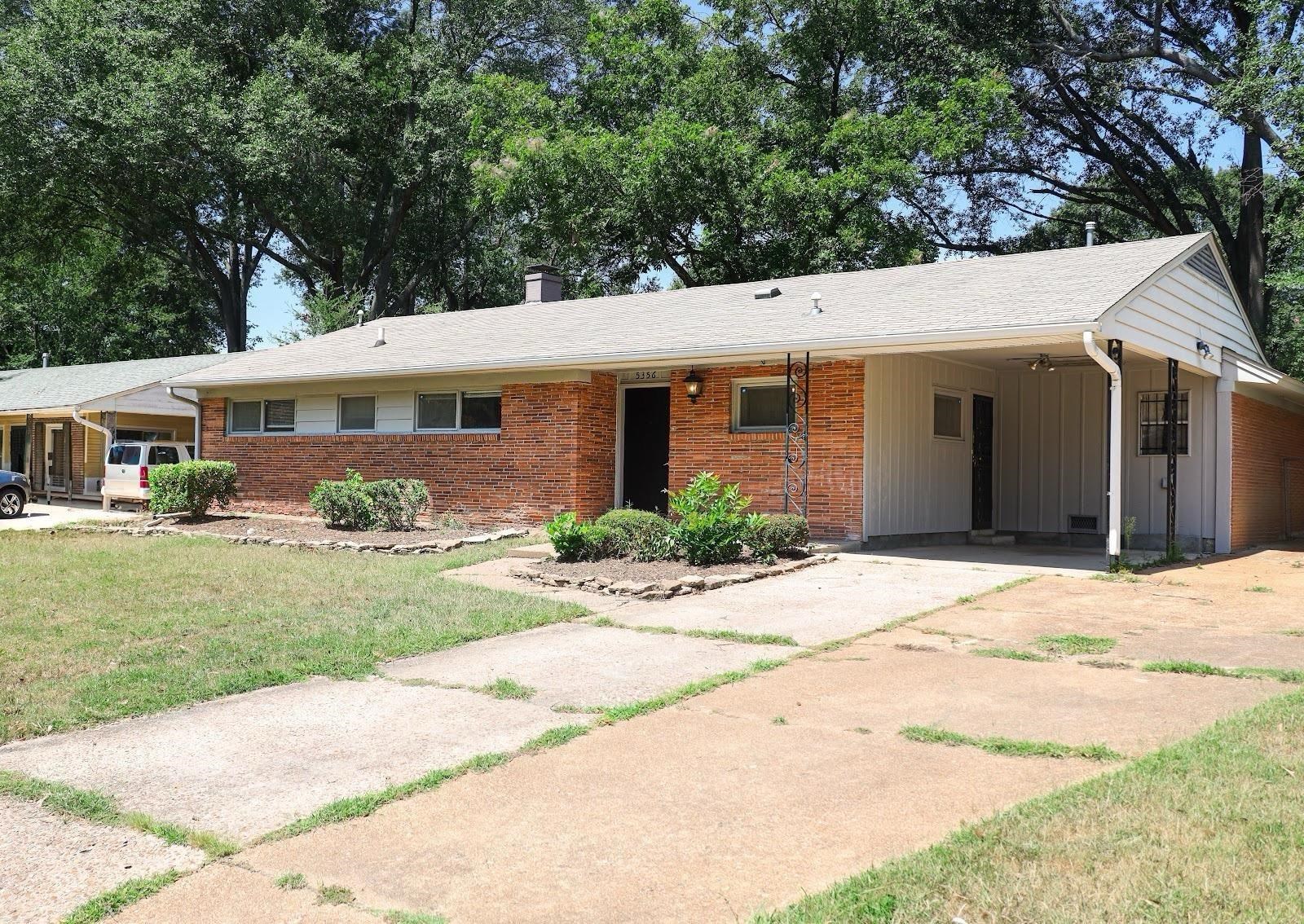 Ranch-style house with a carport and a front yard